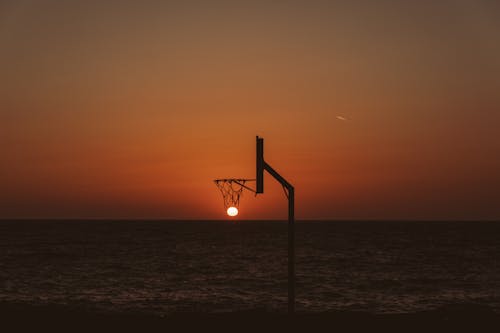 Free Basketball backboard against picturesque sundown Stock Photo